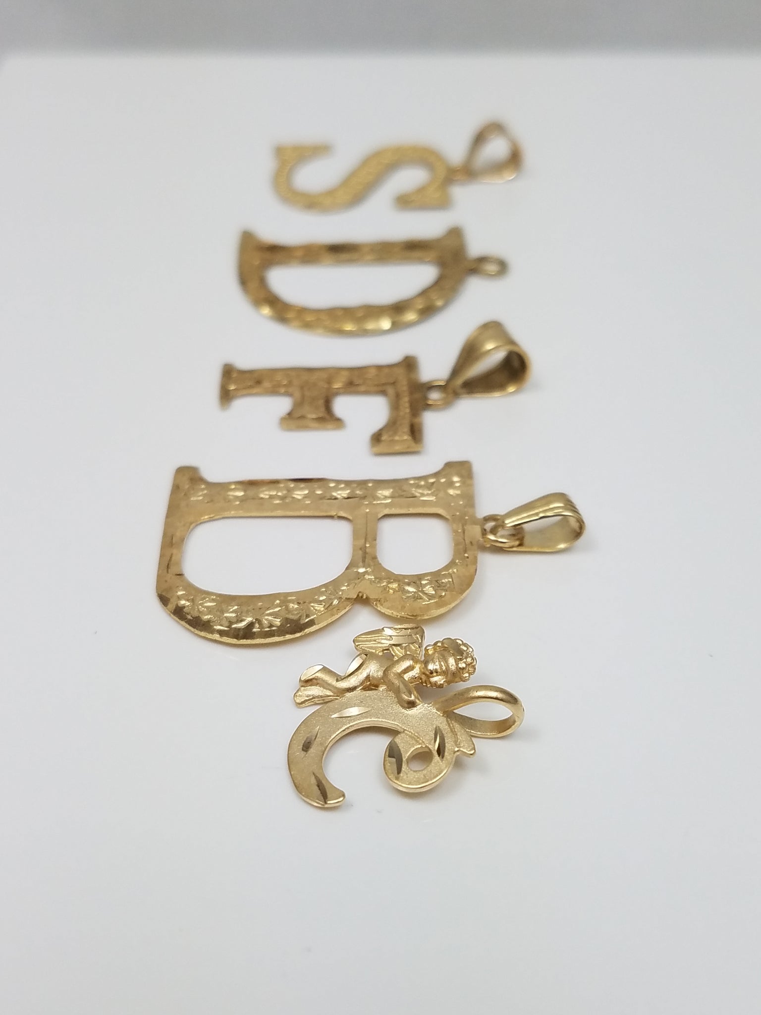 Five Assorted 10k Yellow Gold Initial Lot