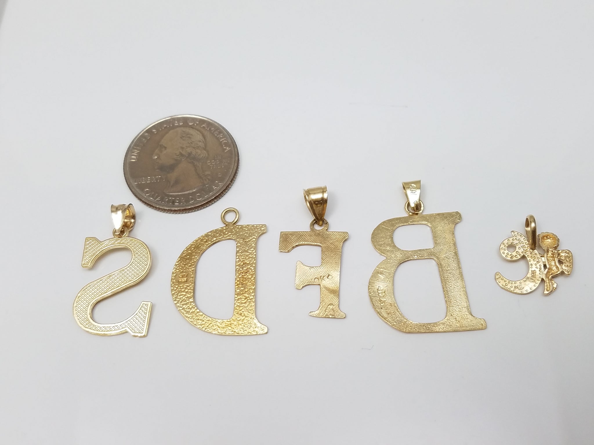 Five Assorted 10k Yellow Gold Initial Lot